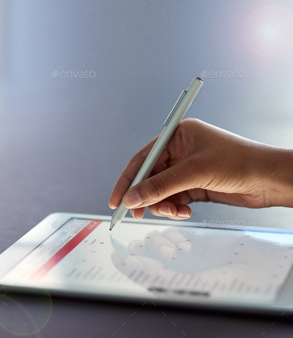 Business made easy with less paperwork. Shot of a businesswoman using a stylus on a digital tablet.