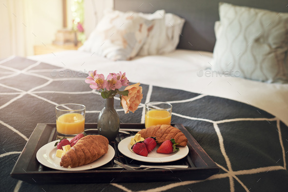 Nothing better than breakfast in bed. Shot of a tray with breakfast on a bed.