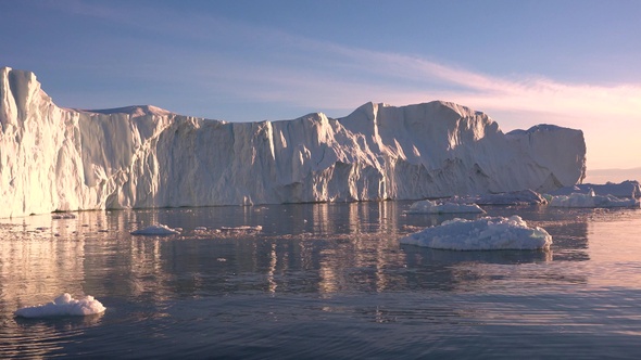 Arctic sailing among glaciers and floating ice blocks, in frozen sea and breathtaking landscape alt