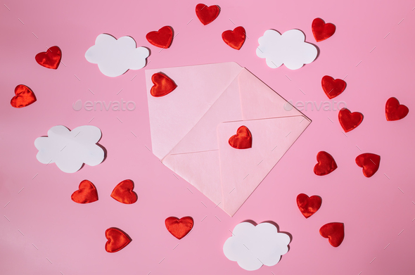 An open postal envelope with red hearts and clouds flying out of it. Hearts flying out of an open