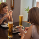 Two girl friends during dinner in modern restaurant - PhotoDune Item for Sale