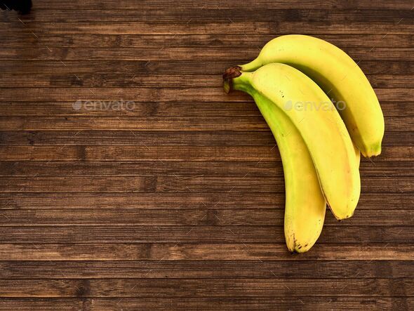 Fresh Organic Ripe Bananas and Raw Bananas in One Banana Bunch on a Wooden  Picnic Table Stock Image - Image of market, natural: 66177521