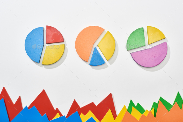 top view of multicolor statistic graphs and pie charts on white background