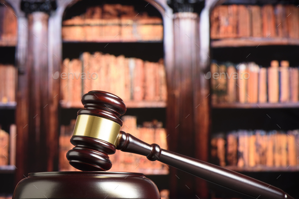 Close up of wooden judge gavel. Blury book library background - Stock Photo - Images