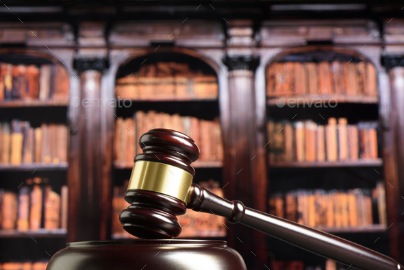 Close up of wooden judge gavel. Blury book library background - Stock Photo - Images