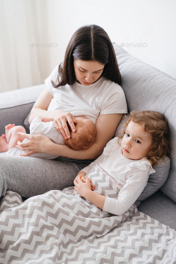 Baby breastfeed and sleep on mothers hands Stock Photo by ninelutsk
