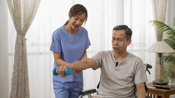 nursing aide helping mature male wheelchair user