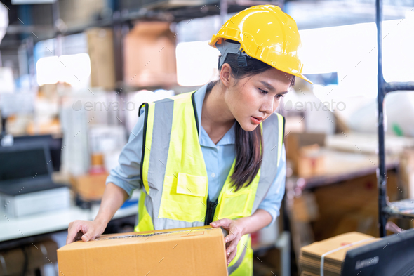 Worker working in the large depot storage warehouse happy smiling packing box at cashier counter