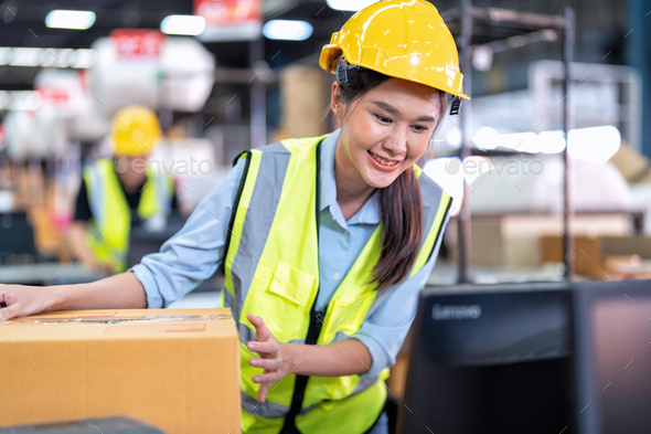 Worker working in the large depot storage warehouse happy smiling packing box at cashier counter
