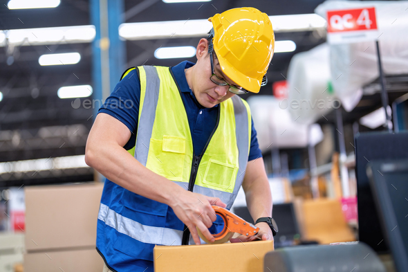 Worker in large depot storage warehouse use adhesive tape prepare packing box at cashier counter