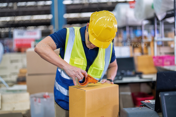 Worker in large depot storage warehouse use adhesive tape prepare packing box at cashier counter