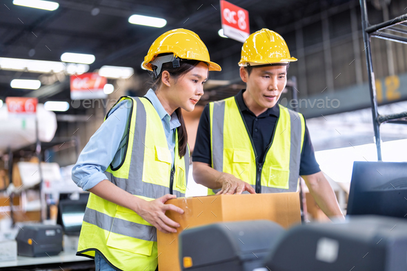 Staff working in large depot storage warehouse trainee check packing box and scan at cashier counter