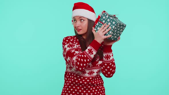 Funny Girl Wears Christmas Holiday Sweater Received Present Interested in What Inside Gift Box alt