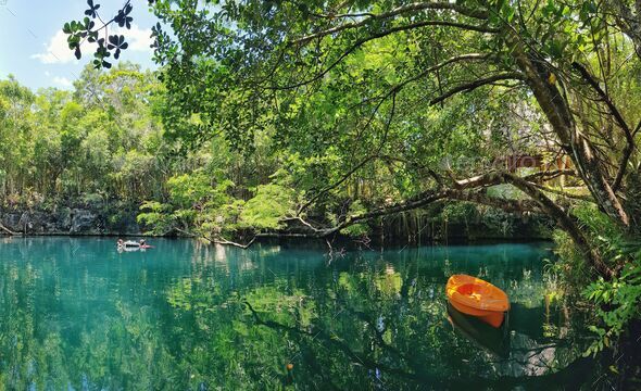 Couple of boats in the swamp of Cenote Angelita in Tulum, Quintana Roo, Mexico - Stock Photo - Images