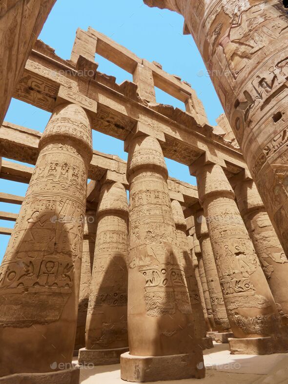 Wonderful pillars of the design of Egyptian Karnak temple in Luxor city Stock Photo by wirestock