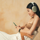 Side view of asian millennial girl in headphones video chatting with her boyfriend using phone app - PhotoDune Item for Sale