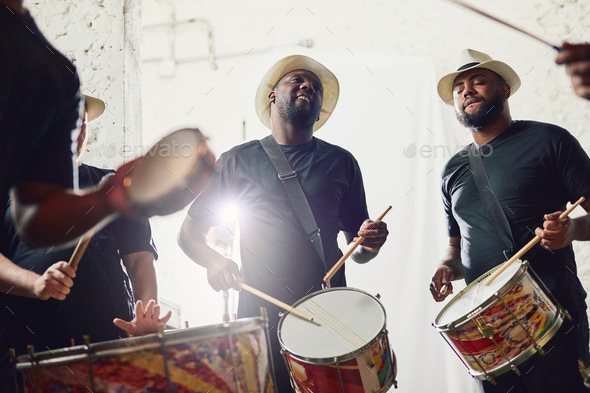 Their beats are on a whole new level. Shot of a group of musical performers playing drums together.