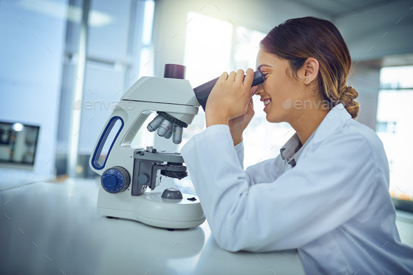 What a fascinating find we have here...Shot of a young scientist using a microscope in a lab.