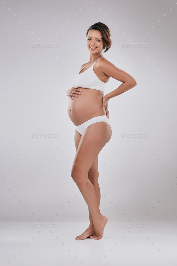 Studio shot of a beautiful young pregnant woman posing in