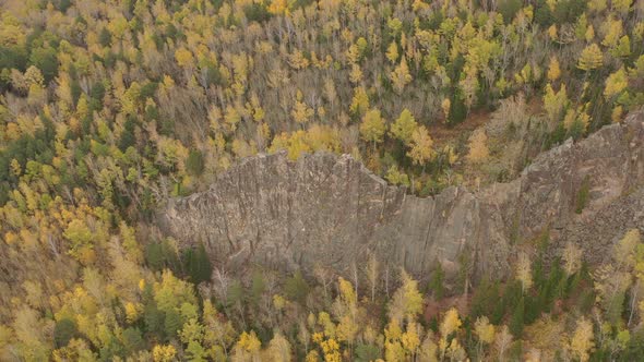 Aerial View of the Rock Among the Autumn Forest.