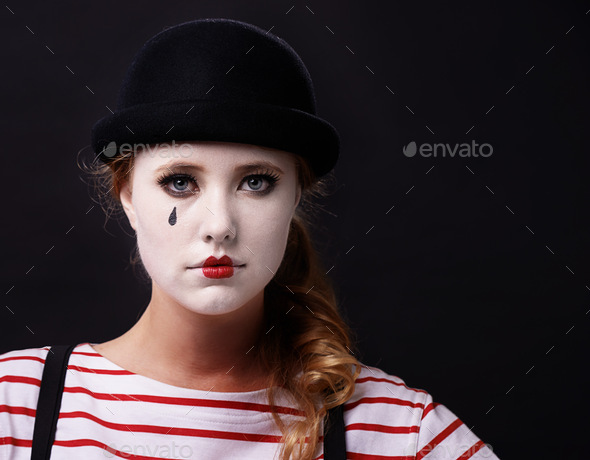 Allow me to mime a sad story. Studio shot of a female mime.