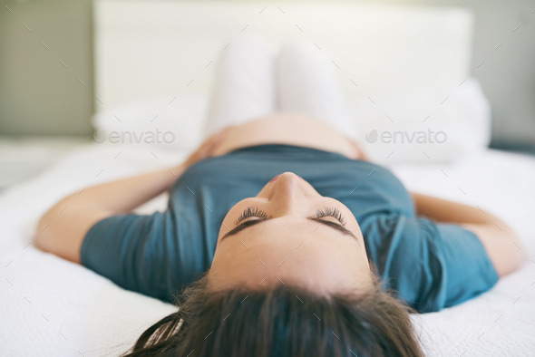 Taking it easy on my last trimester. Shot of a young pregnant woman relaxing at home.