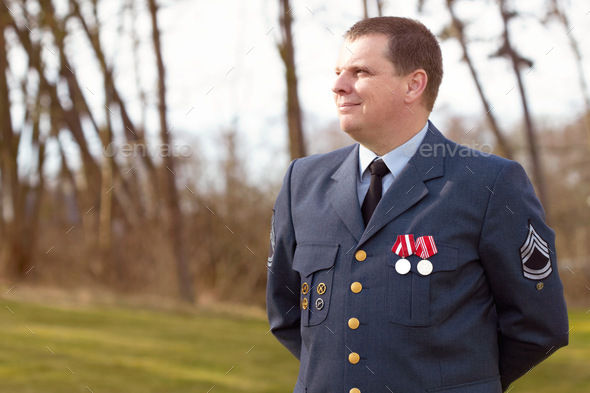 Serving his country. Shot of a high ranking military officer standing at ease in the outdoors.