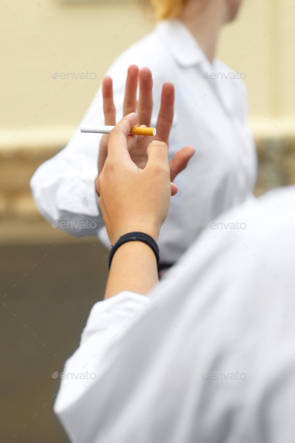 Cropped shot of a young female studentd turning down cigarettes in response to peer pressure