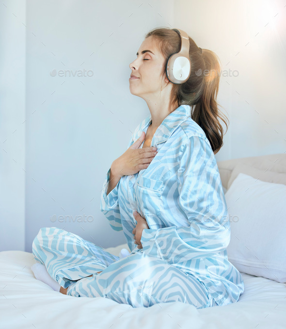 Woman, morning and headphones for meditation on bed while listening to music or podcast while breat