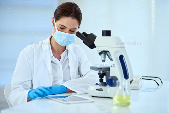 Observe carefully to help maintain accuracy. Shot of a female scientist working alone in the lab.