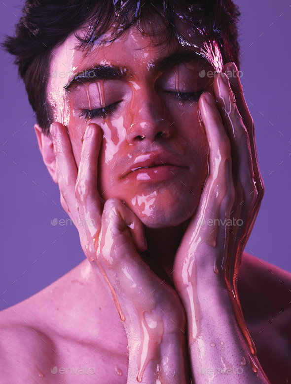 Model, man and skincare with honey dripping on face, cosmetics and organic beauty by purple backdro