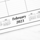 Overhead view of a desktop calendar showing text February 2023 and miniature monthly  calendars  - PhotoDune Item for Sale