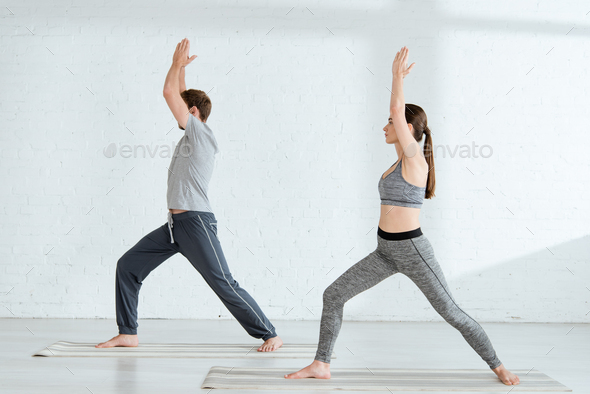 Woman With One Arm In Warrior Pose During Hot Yoga Class In Exercise Studio  High-Res Stock Photo - Getty Images