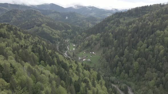 Village in the Mountains. Slow Motion. Carpathians. Ukraine. Aerial. Gray, Flat alt