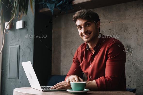 Smiling Babe Freelancer Working On Laptop And Drinking Coffee In Coffee Shop Stock Photo By