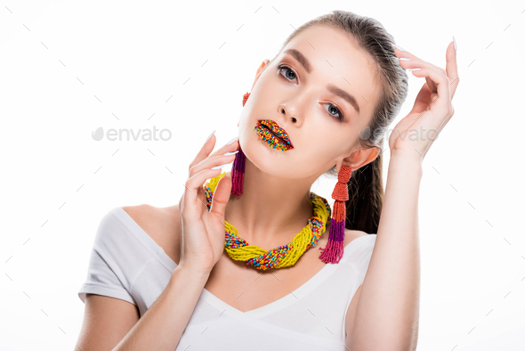 beautiful girl in beaded accessories, with beads on lips, looking at camera isolated on white