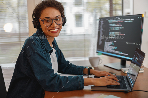 Afro american woman in headphones freelance data scientist work remotely at home office - Stock Photo - Images