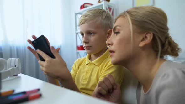 Cute Boy Showing Mother New Smartphone Application, Modern Technologies, Gadgets