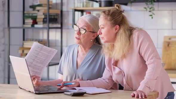 Woman Teaching Mother To Use Internet at Home alt
