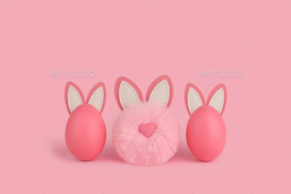  Pink Easter fluffy bunny and two eggs with ears on a pink background.