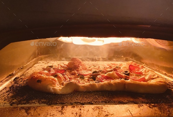 Making homemade pizza in the pizza oven - Stock Photo - Images
