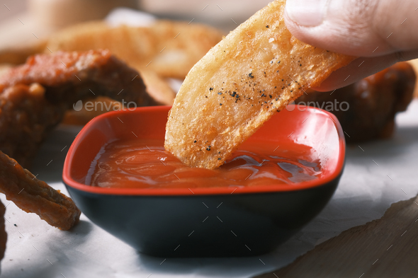 Tasty freshly made wage potato chips and sauce on table  - Stock Photo - Images