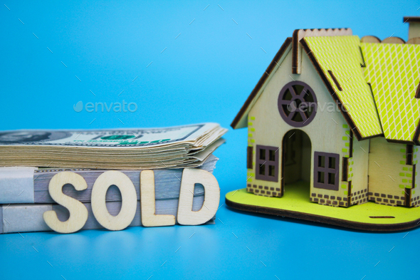 house model and money with the word sold