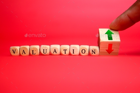 wooden cube with the word valuation and up and down arrows