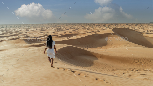 Dubai dessert sand dunes, Asian women on Dubai desert safari,United Arab Emirates