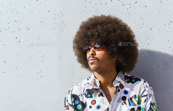 closeup of young black guy with afro hair in white shirt