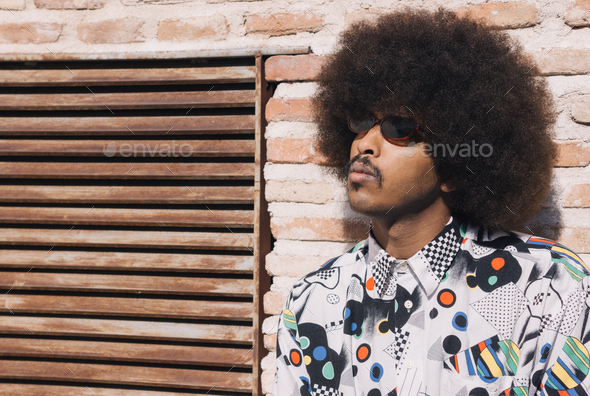 young black guy with mustache and red sunglasses with afro hair