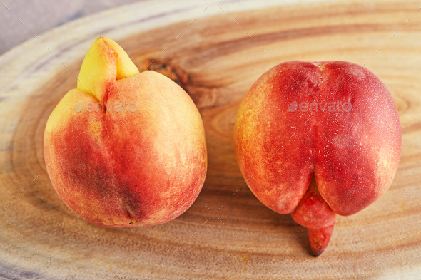 An ugly fruit or vegetable. A very ugly peach mutant on a wooden stand.