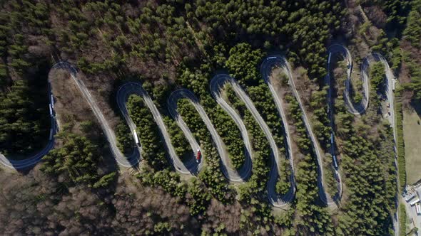 Bird's eye static aerial view of switchback highway over Bratocea Pass, Romania alt