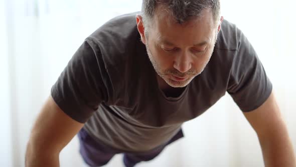 Handsome Man Doing Abs Exercises at Home During Quarantine alt